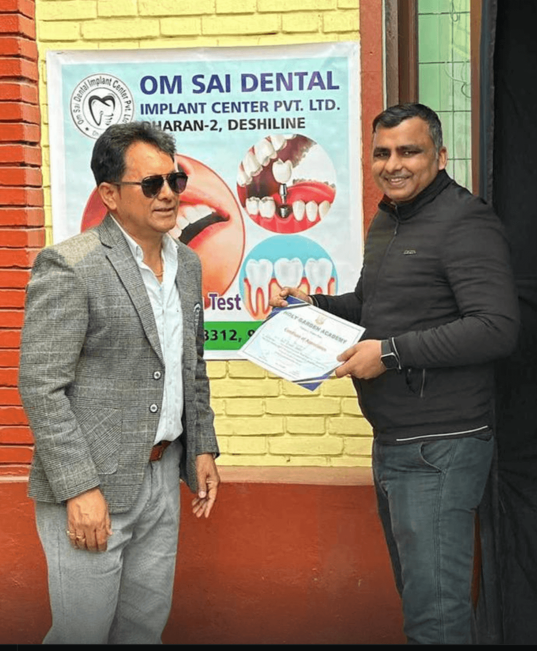 Dr. Ajit Yadav at Om Sai Dental Implant Center, Dharan-2 Deshiline, receiving a certificate of appreciation